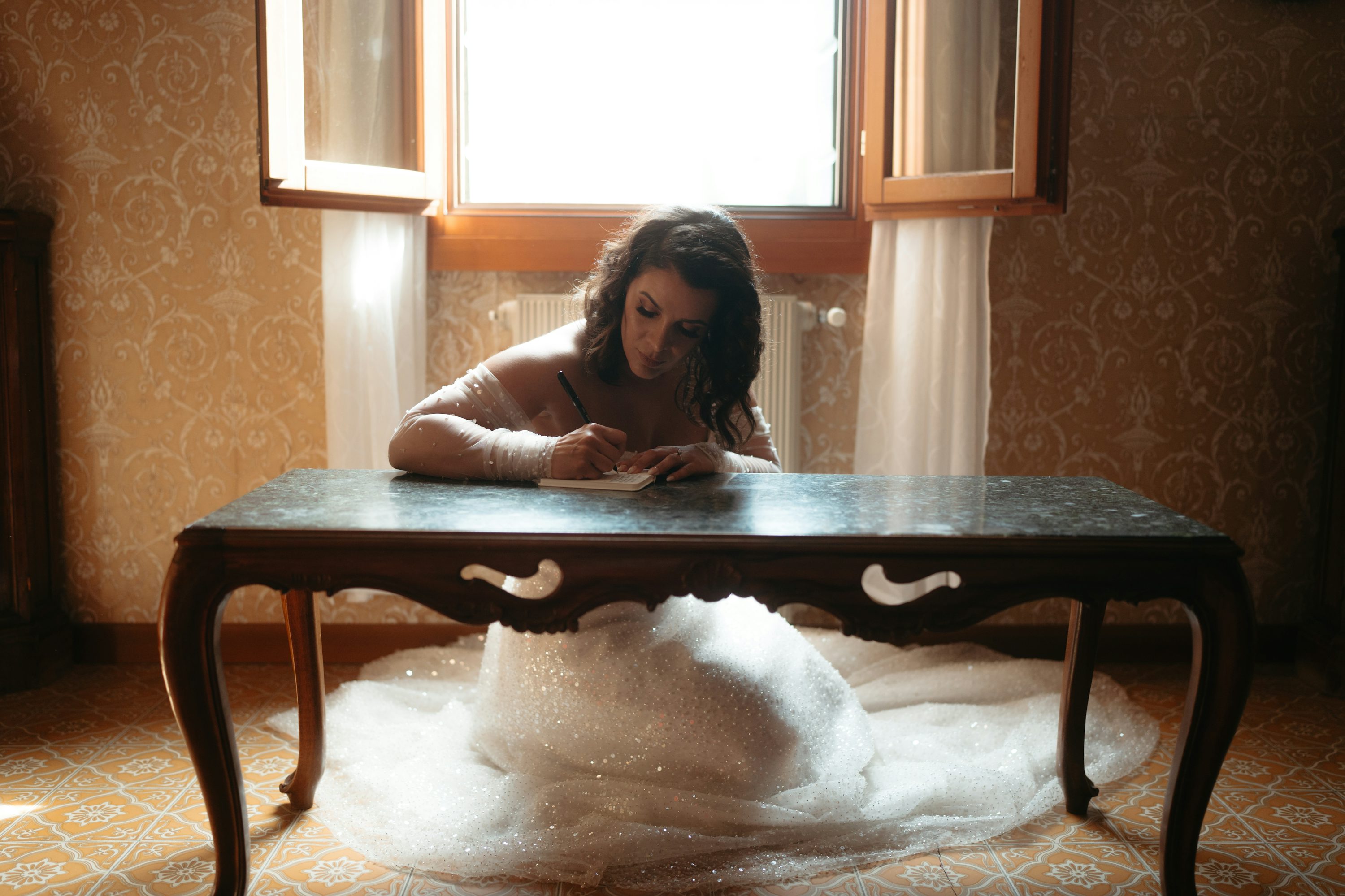 Writing vows in soft window light