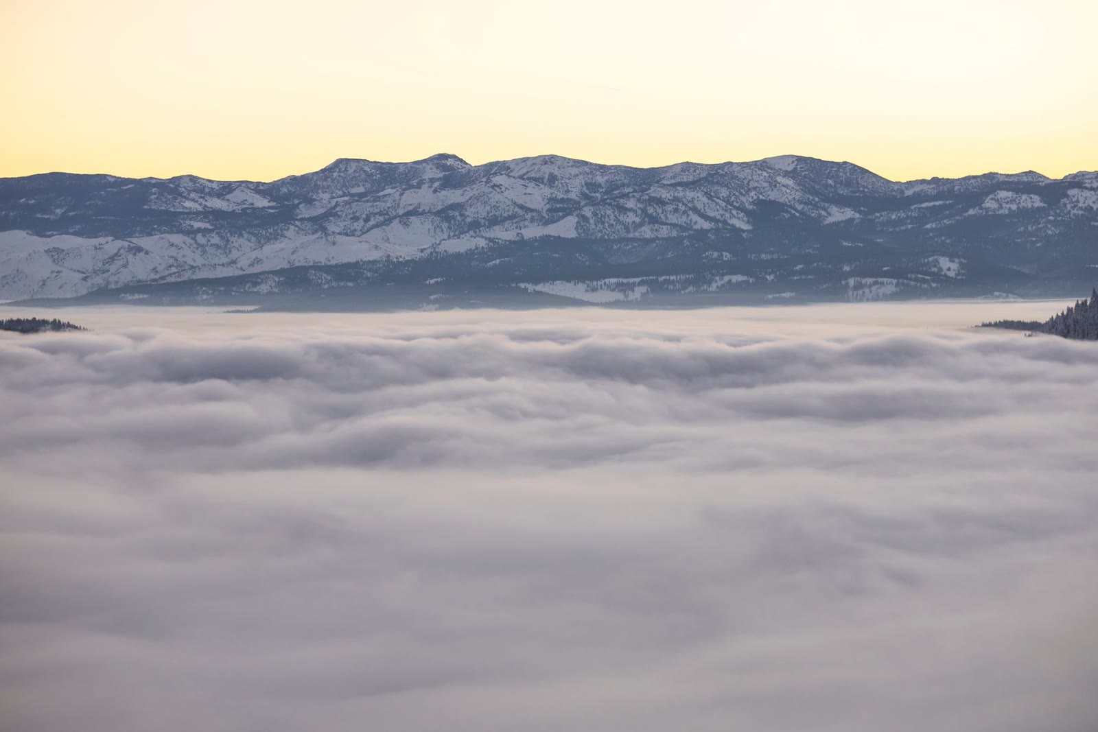 Mountain peaks above morning mist.